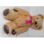 A pale plush covered teddy bear with mechanical opening mouth operated by lever at back of head,