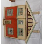 A wood dolls house partly cover including "brick" paper, the two doors open to reveal four rooms,