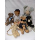 Eight miscellaneous teddy bears.