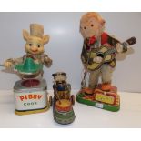 Two battery operated tin and plastic toys, a monkey and a pig, together with one other tin toy.