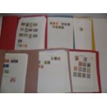 Stamp collections on leaves and in office folders :- Angola, Swaziland, Madagascar, Sudan,