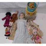 A clockwork dog in a basket, a potty and various dolls including a wax shoulder plate doll.