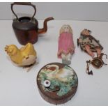 A tin plate circular musical box, a plastic laying hen, a brass telephone, two miniature dolls etc.