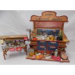 A French shop display shelf unit containing a quantity of grocery tins and packets,