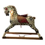 A 20th century carved and painted wooden rocking horse, height 95cm (rockers missing).