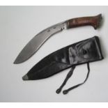 A World War II kukri knife with wooden grip, the blade stamped 'Pioneer Calcutta 1942',