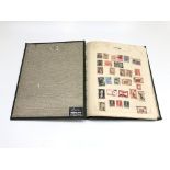 A stamp album containing a collection of foreign stamps, mostly pre 1950s.