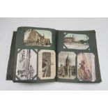 An early 20th century postcard album and contents including British and European royalty, churches,