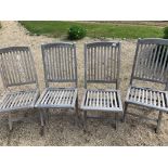 Four folding teak chairs.