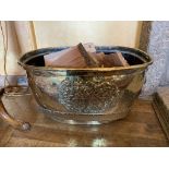 An early 19th century brass log bin, with armorial decoration and lion's mask handles. (