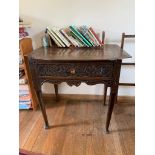 A carved oak lowboy, 18th century, with single frieze drawer on circular tapering legs and pad feet.