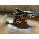 A Royal Crown Derby paperweight in the form of a bottle nosed dolphin. (Dimensions: Width 20cm.)(