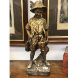 A Goldscheider gilt decorated pottery figure of a boy with a rabbit, impressed 'Fabrique en