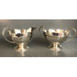 An Edwardian Arts and Crafts silver twin handled sugar bowl and matching jug by L. S. B. Birmingham,