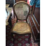 Four French walnut side chairs, with rattan back and seats, on cabriole legs. (Dimensions: Height
