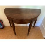 A George III mahogany demi lune fold over tea table. (Dimensions: Height 75cm, width 94cm)(Height