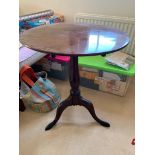 A George III mahogany tripod table, on baluster stem, on downswept cabriole legs with pad feet. (