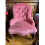 A Victorian upholstered tub armchair with turned tapering legs. (Dimensions: Height 81cm)(Height
