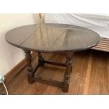 A 17th century style oak drop leaf table. (Dimensions: Height 47cm, width 67cm)(Height 47cm, width