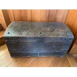 An 18th century metal bound and leather covered wooden dome top trunk with studded decoration