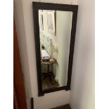 A carved oak framed wall mirror. (Dimensions: Height 140cm, width 61cm)(Height 140cm, width 61cm)