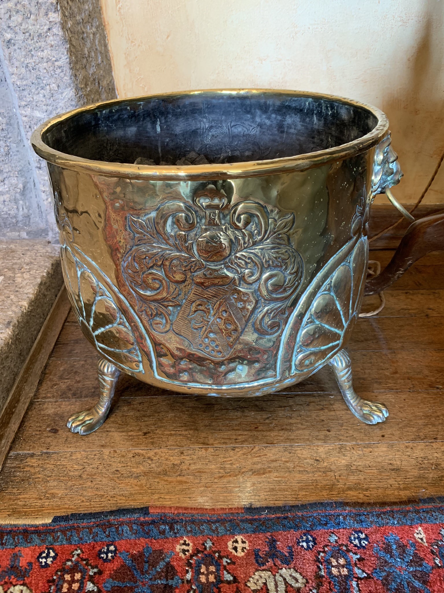 A 19th century brass log bin, with lion's mask handles. (Dimensions: Height 34cm, diameter 38cm)(