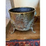 A 19th century brass log bin, with lion's mask handles. (Dimensions: Height 34cm, diameter 38cm)(