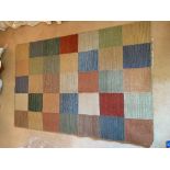 A Gabbeh flat woven rug, with rows of polychrome squares. (Dimensions: 180cm x 120cm)(180cm x