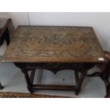 A 17th/18th century carved oak side table, with a single frieze drawer above a shaped apron, on