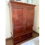 An Edwardian mahogany gentleman's wardrobe, with a pair of panelled doors opening to reveal