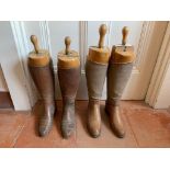 Two pairs of leather riding boots, with wooden trees.