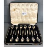 A set of 12 pre-war silver coffee spoons, cased.