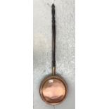 A Victorian copper warming pan. (Dimensions: Height 106cm.)(Height 106cm.)