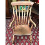 An ash and elm lathe back armchair, late 19th century.