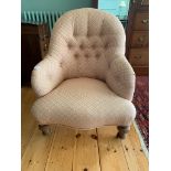 A Victorian tub armchair, with a padded back, arms and seat, on turned tapering legs. (Dimensions: