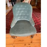 A Victorian upholstered tub armchair with turned tapering legs. (Dimensions: Height 76cm)(Height