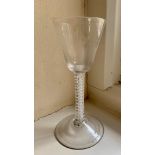 An 18th century wine glass with multiple opaque spiral twist stem.