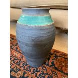 A studio pottery vase by Essex Tyler, with a green glazed horizontal band, stamped with the initials