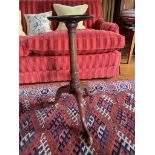 A George III mahogany candle stand, with baluster stem on downswept cabriole legs and pad feet. (