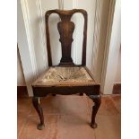 An oak dining chair, 18th century, the shaped solid splat above a drop-in wicker seat, on cabriole