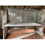 A painted wooden settle.