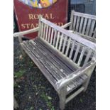 A pair of teak garden benches