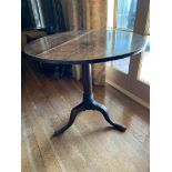 A George III oak tripod table, the ring turned stem on downswept cabriole legs with pad feet. (