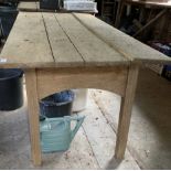 An Arts and crafts weathered light oak Cotswolds style dining table, the top of three planks on