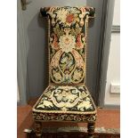 A Victorian prayer chair, with floral and leaf decorated needlepoint covered back and seat, on