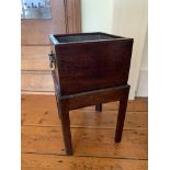 A George III mahogany wine cooler, the square body with liner, on square chamfered legs. (