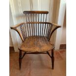 An ash and elm stick filled Windsor armchair, the dished seat on turned tapering legs. (