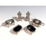 An Adie Brothers Ltd silver cruet comprising two open salts, two mustards and two pepper pots,
