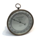 An aneroid barometer by Wheeler, London, Mark II, admiralty mark to rear, in circular brass case. (