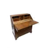 A George III oak bureau, with four long graduated drawers on bracket feet. (Dimensions: Height